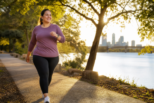 Woman walking briskly on a tree-lined path for cardio exercise and weight loss