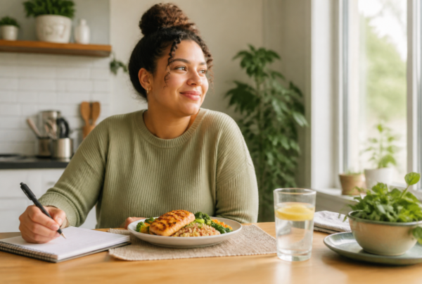 Woman reviewing a balanced meal plan at a kitchen table during reverse dieting